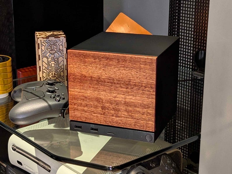A solid wood sapele faceplate for the 2026 Steam Machine, made from genuine wood.