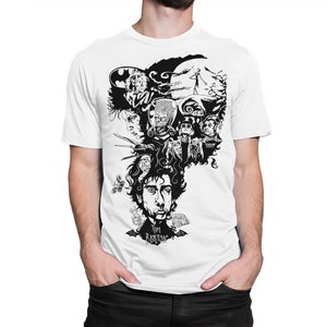 May include: White t-shirt featuring a black and white graphic of Tim Burton and characters from his films. The design includes Beetlejuice, Jack Skellington, and Edward Scissorhands. The text "Tim Burton" is printed at the bottom of the design.