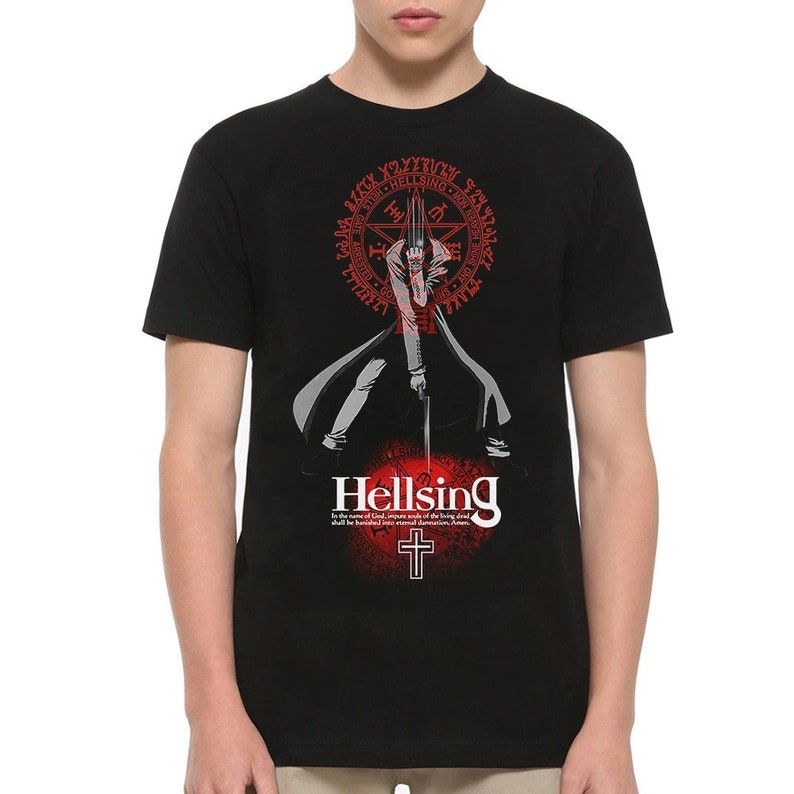 May include: Black t-shirt featuring a graphic from the anime series Hellsing. The design includes a central character with a sword, surrounded by a red circular emblem and the word "Hellsing" in white. A cross is below the text.
