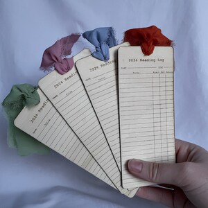 Hand holding bookmarks to help give a size reference