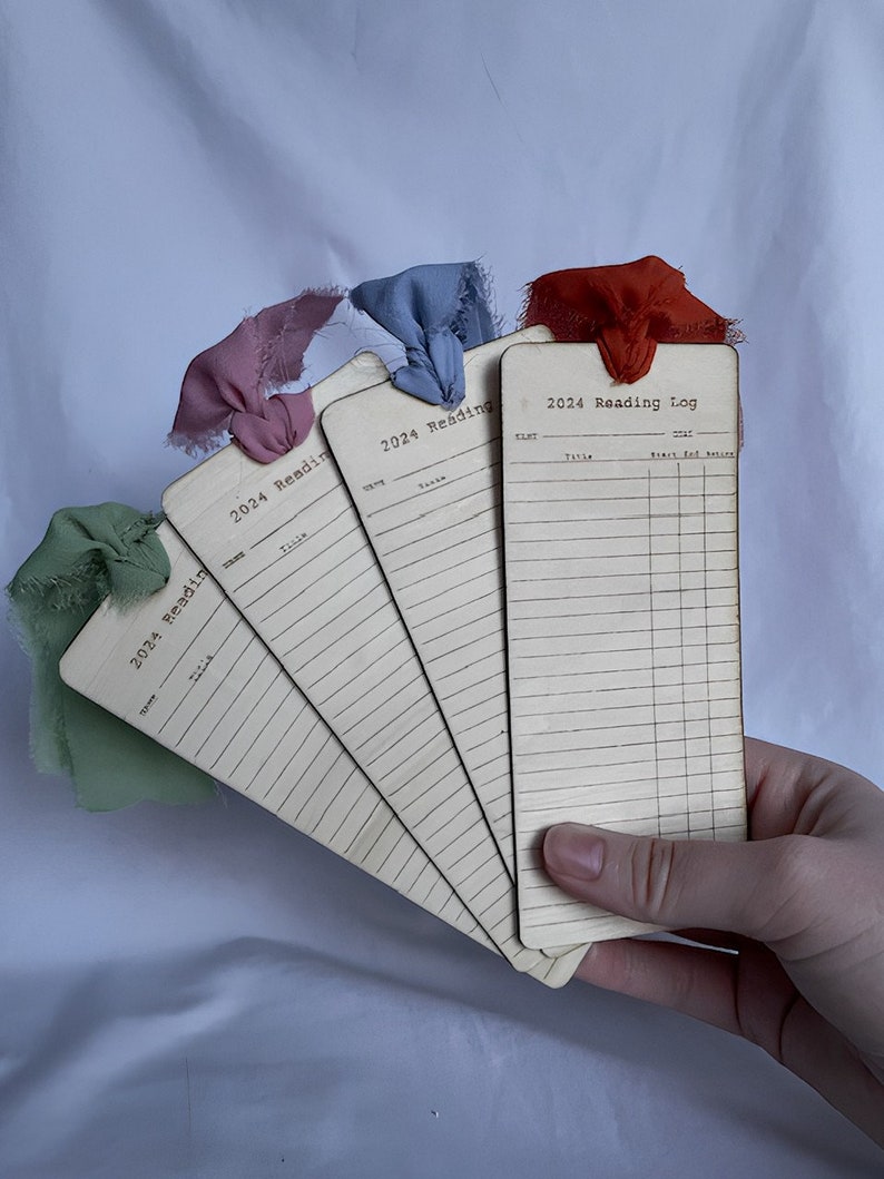 Hand holding bookmarks to help give a size reference