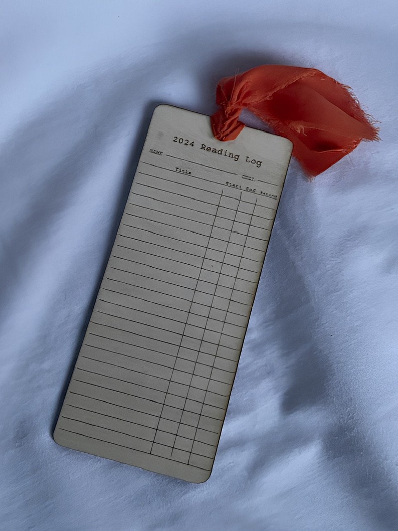 The front side of a bookmark from a straight on view. Shows booktitles, when you started the book, end time, and what your rating would be of the book. You can date your reading list bookmark!