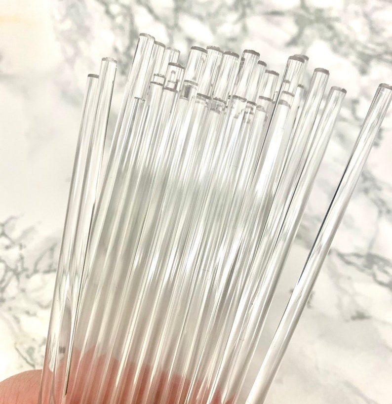 May include: A bundle of clear glass rods, approximately 12 inches long, for crafting and art projects.