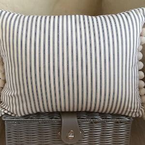 Navy and Cream Ticking Stripe cushions with pom-poms