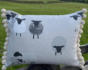 Sheep design cushion with pom-poms