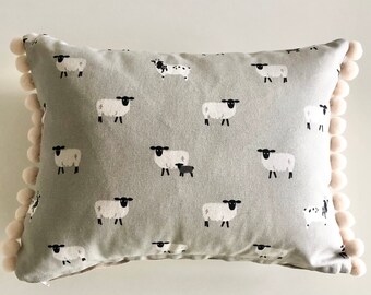 Sophie Allport sheep cushion with pom-poms