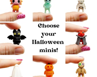 May include: A collection of eight miniature Halloween-themed figurines including an axolotl in a pumpkin, a translucent alien, a skeleton, a black bat, a vampire, a white ghost, a jack-o'-lantern, and a stitched doll, with the text Choose your Halloween minis!