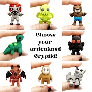May include: A collection of eight small articulated creature figurines including a red-horned grey monster, a lime green Cthulhu, a brown werewolf, a green dinosaur, a black moth-like figure, a red devil, a brown Bigfoot, and a grey goat-like creature.