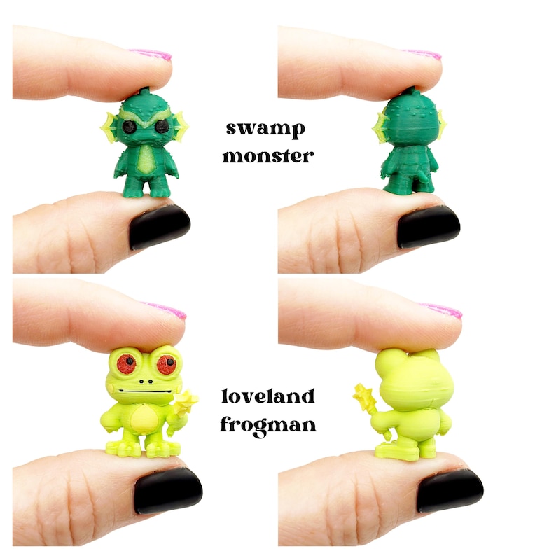 May include: Miniature green Swamp Monster and Loveland Frogman figurines. The Swamp Monster has a textured head and fins. The Loveland Frogman is lime green with red eyes and a yellow star. Text reads "swamp monster" and "loveland frogman".