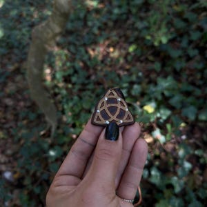 Triquetra necklace handmade in walnut wood with brass and sterling silver nails