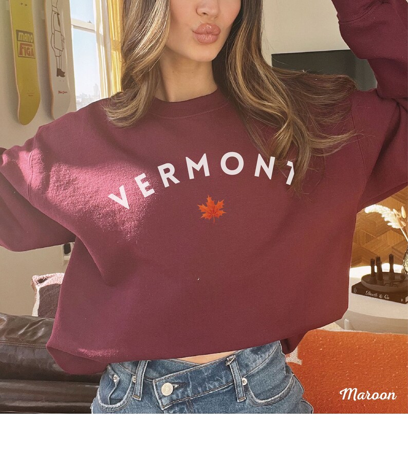 May include: A maroon sweatshirt with the word "VERMONT" in white lettering and a red maple leaf.