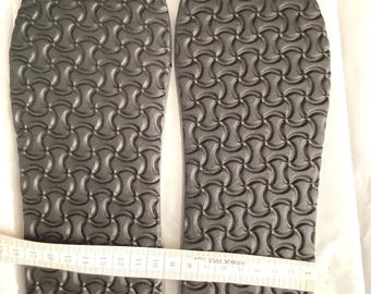 May include: A pair of black shoe insoles with a textured pattern. The insoles are measured with a tape measure, showing a length of 11 inches.