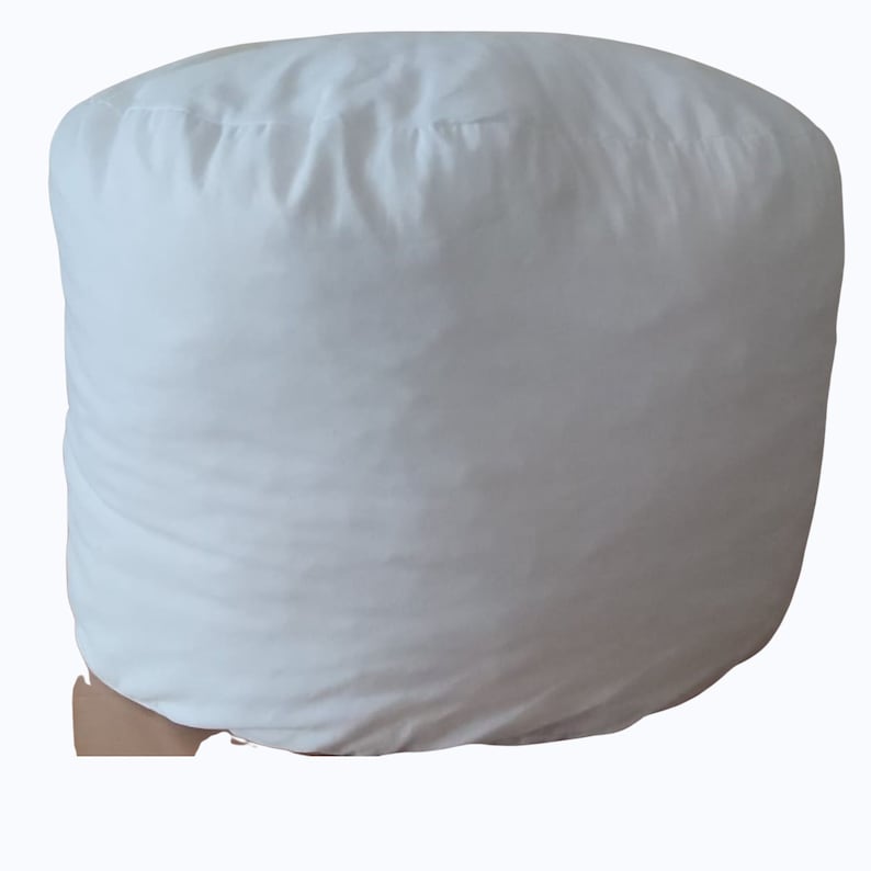 May include: A white round beanbag chair with a smooth, soft fabric cover.