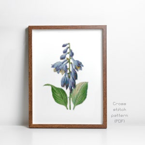 May include: A framed cross stitch pattern of a blue flower with green leaves. The pattern is titled "Cross stitch pattern (PDF)".