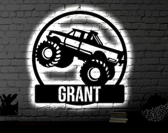May include: Black and white silhouette of a monster truck with the name "GRANT" on a white background.