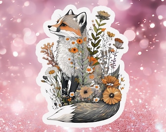 May include: A sticker featuring a fox sitting in a field of flowers. The fox is gray and white with orange accents. The flowers are a mix of white, yellow, and orange.
