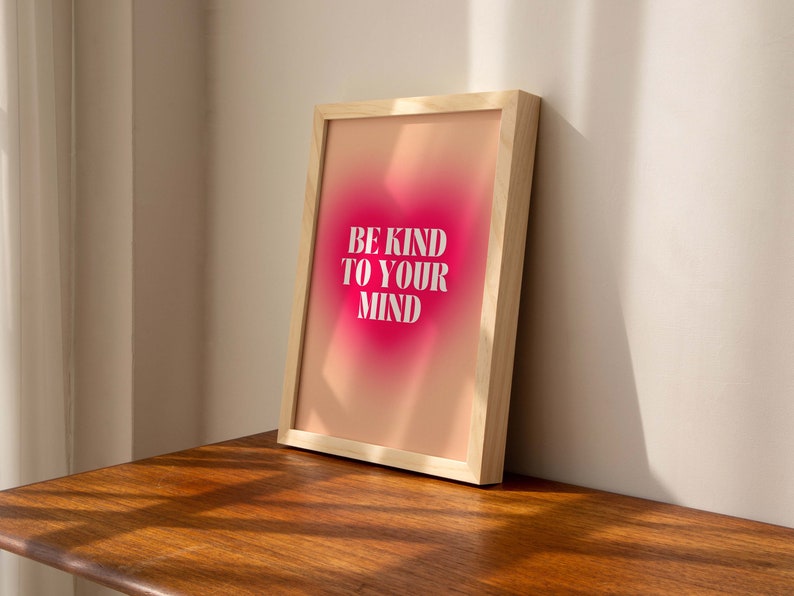 May include: A framed print with a pink and orange gradient background. The text "BE KIND TO YOUR MIND" is printed in white on the print.