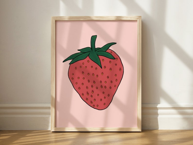 May include: A framed illustration of a red strawberry with green leaves on a pink background.