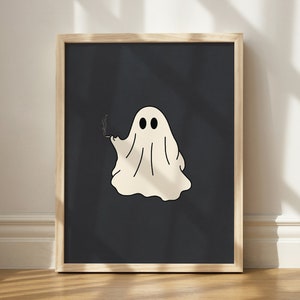 May include: A framed print of a white ghost with two eyes and a cigarette in its hand, on a dark blue background.