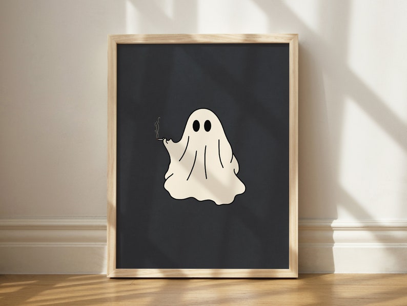 May include: A framed print of a white ghost with two eyes and a cigarette in its hand, on a dark blue background.