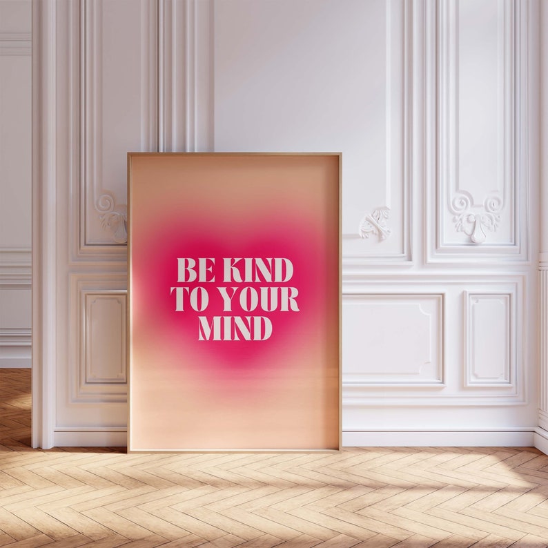 May include: A framed poster with a pink and orange gradient background. The text "BE KIND TO YOUR MIND" is printed in white on the poster.