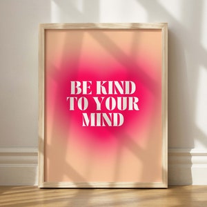 May include: A framed print with a pink and orange gradient background. The text "BE KIND TO YOUR MIND" is printed in white on the print.
