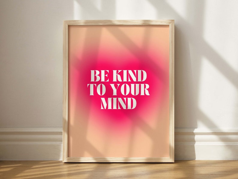 May include: A framed print with a pink and orange gradient background. The text "BE KIND TO YOUR MIND" is printed in white on the print.