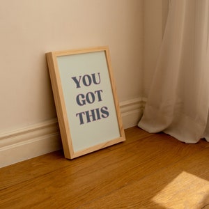 May include: A framed print with a light green background and the text "YOU GOT THIS" in dark gray letters.