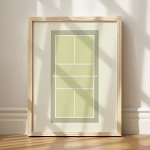 May include: A framed print of a tennis court with green lines on a light green background.