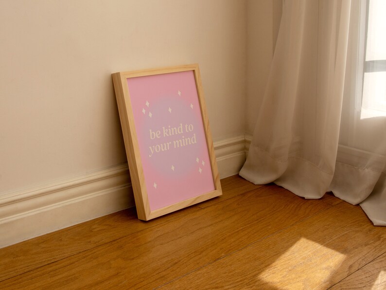 May include: A framed print with a pink and purple ombre background and white text that reads "be kind to your mind".