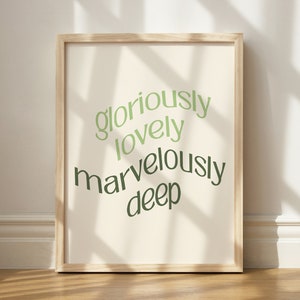 May include: A framed print with a white background and green text that reads "gloriously lovely marvelously deep".