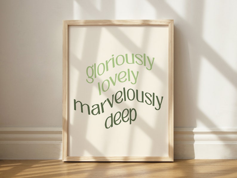 May include: A framed print with a white background and green text that reads "gloriously lovely marvelously deep".