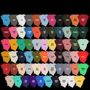 May include: A colour chart of 50 different t-shirt colours, including aqua, army, ash, asphalt, autumn, baby blue, berry, black, brown, burnt orange, canvas red, cardinal, charity pink, citron, columbia blue, coral, dark grey, dark olive, deep teal, dusty blue, evergreen, forest, fuchsia, gold, kelly, leaf, light blue, lilac, maize yellow, maroon, mauve, military green, mint, mustard, natural, navy, ocean blue, olive, orange, orchid, oxblood black, pebble, pink, poppy, red, rust, sand dune, silver, soft cream, soft pink, solid athletic grey, steel blue, storm, sunset, synthetic green, tan, teal, team navy, team purple, true royal, turquoise, vintage black, vintage white, white, and yellow.