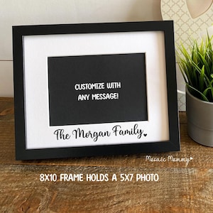 May include: Black picture frame with a white mat and a black background. The frame has the text "Customize with any message!" and "The Morgan Family." The frame is 8x10 inches and holds a 5x7 inch photo.