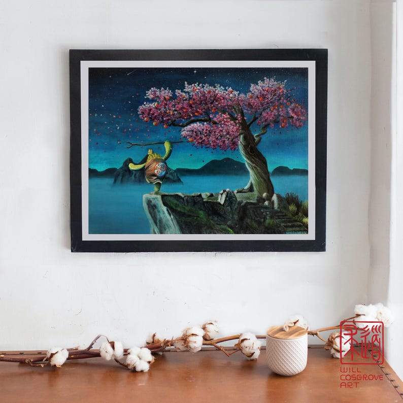 May include: A framed painting depicts a turtle character on a cliff, holding a stick, with a blooming pink tree and a starry night sky. The artwork is set against a backdrop of mountains and water, with the artist's signature in the bottom right corner.
