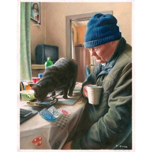 May include: A man wearing a blue beanie sits at a table with a black cat. The man is holding a white mug and the cat is eating from a plate. The table is covered in a checkered tablecloth and there are various items on the table, including a mobile phone, a glass, and a container of butter.