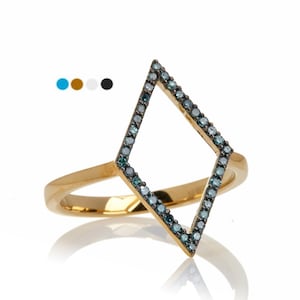 May include: A gold-colored ring featuring a diamond-shaped design. The diamond shape is outlined with small, teal-colored gemstones. The ring has a polished finish and is set against a white background.