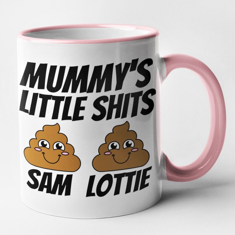 May include: White ceramic mug with a pink rim and handle. The mug has a black graphic that says "Mummy's Little Shits" with two cartoon poop emojis underneath. The poop emojis have smiling faces and the text "Sam" and "Lottie" underneath.