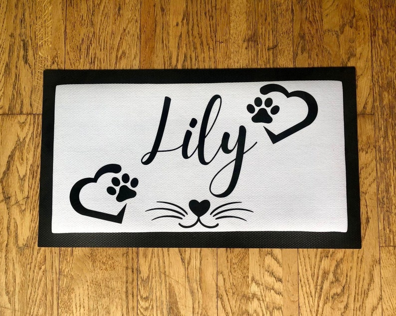 May include: Black and white doormat with the name "Lily" and paw prints in hearts.