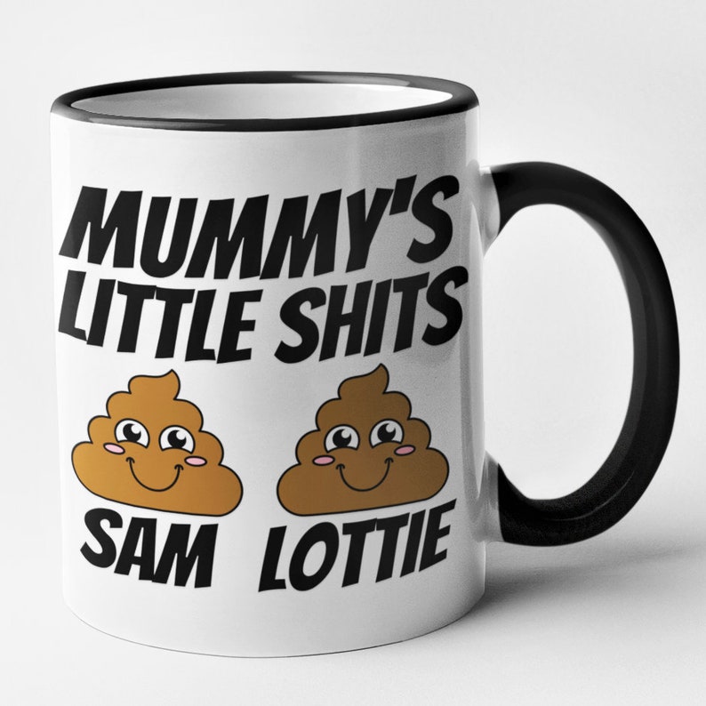 May include: White ceramic mug with a black rim and handle. The mug has a black graphic that says "Mummy's Little Shits" with two cartoon poop emojis with faces and the names "Sam" and "Lottie" underneath.