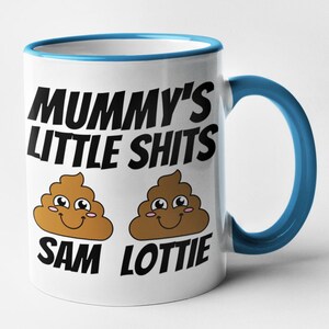 May include: White ceramic mug with a blue rim and handle. The mug has a black graphic that says "Mummy's Little Shits" with two cartoon poop emojis with smiling faces. The text "Sam" and "Lottie" are below the emojis.