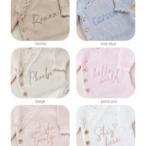 May include: A collection of six knitted cardigans in mocha, misty blue, beige, petal pink, blush, and dusty pink. Each cardigan features wooden buttons, a scalloped edge, and embroidered text including Roman, Carson, Phoebe, hello world, isn't she lovely, and She's here.