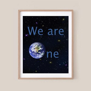 May include: Framed art print featuring a vibrant image of Earth set against a starry night sky. The words "We are one" are displayed in blue. The artwork is encased in a light brown wooden frame.