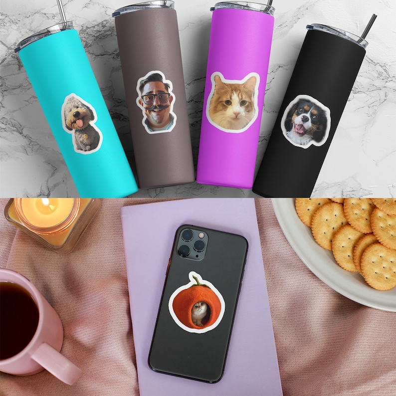 May include: Four cylindrical tumblers in turquoise, brown, magenta, and black, each featuring a unique custom sticker of a dog, a person, a cat, or a spaniel. Below, a black smartphone displays a sticker of a cat inside an orange fruit peel.