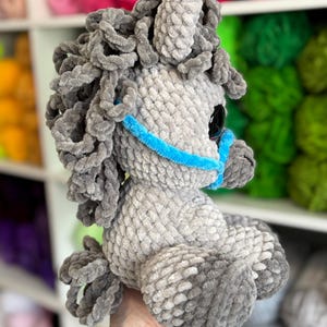 Opposite side profile of the gray Hollie the Horse plushie with defined legs, mane, and halter. A helpful view for crocheters considering the shape and construction of the final item.