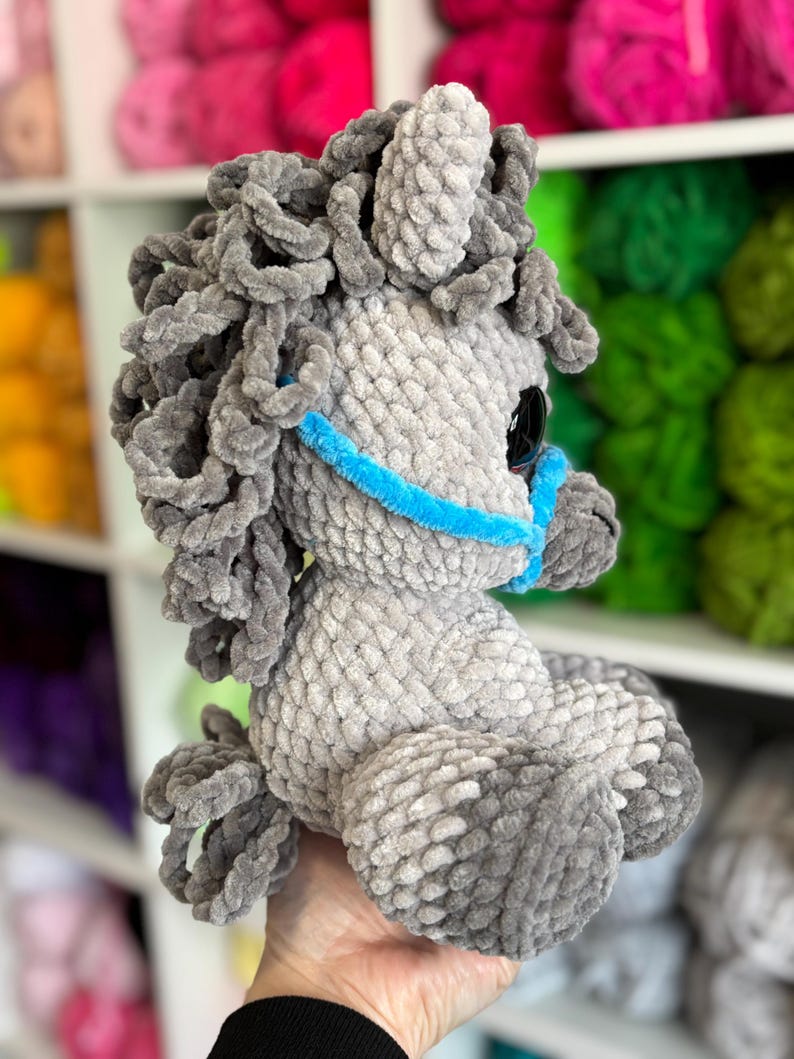 Opposite side profile of the gray Hollie the Horse plushie with defined legs, mane, and halter. A helpful view for crocheters considering the shape and construction of the final item.
