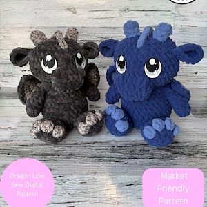 May include: Two handmade crochet dragon plushies, one dark gray and one blue, with large white-eyed faces. The image includes text that reads "Rachel's Handmade Huggables" and "Digital item not physical item."