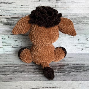 Back view of brown Dylan the Donkey plush showing its fluffy tail and soft texture.