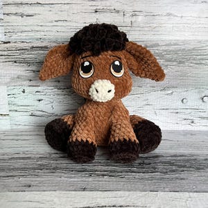 Front view of brown Dylan the Donkey plushie made with soft chenille yarn and felt eyes.