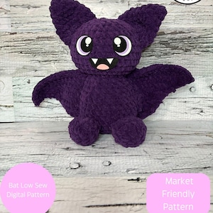 May include: A plush, purple bat with large, round eyes, a smiling mouth, and outstretched wings. The bat is a handmade item, as indicated by the "Rachel's Handmade Huggables" logo. Text on the image states "Digital item not physical item".